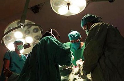 Surgeon operates leg of man with head injuries
