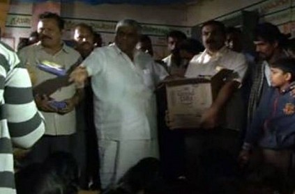 Height of apathy: Minister throws biscuit packets at flood victims